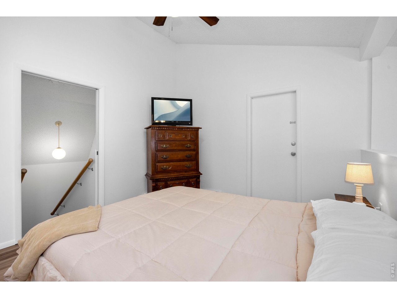 3400 Stanford Road, Unit B223 Fort Collins, CO 80525 - Photo 24 of 34 a bedroom with a bed and a lamp