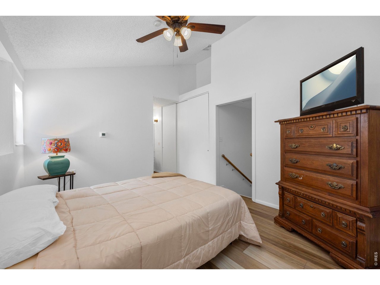 3400 Stanford Road, Unit B223 Fort Collins, CO 80525 - Photo 25 of 34 a bedroom with a bed and flat screen tv
