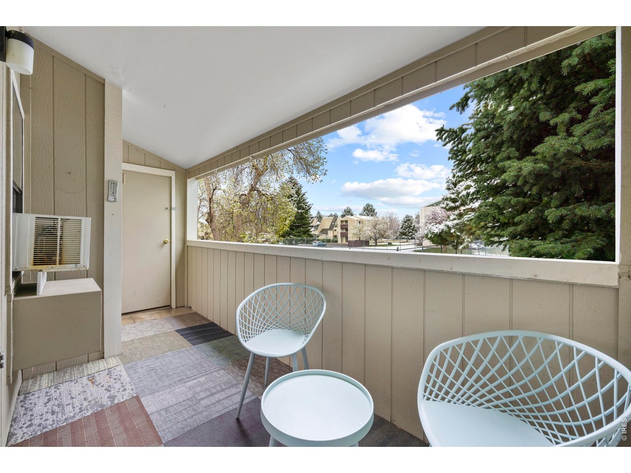 3400 Stanford Road, Unit B223 Fort Collins, CO 80525 - Photo 30 of 34 a balcony view with couple of chairs and couch