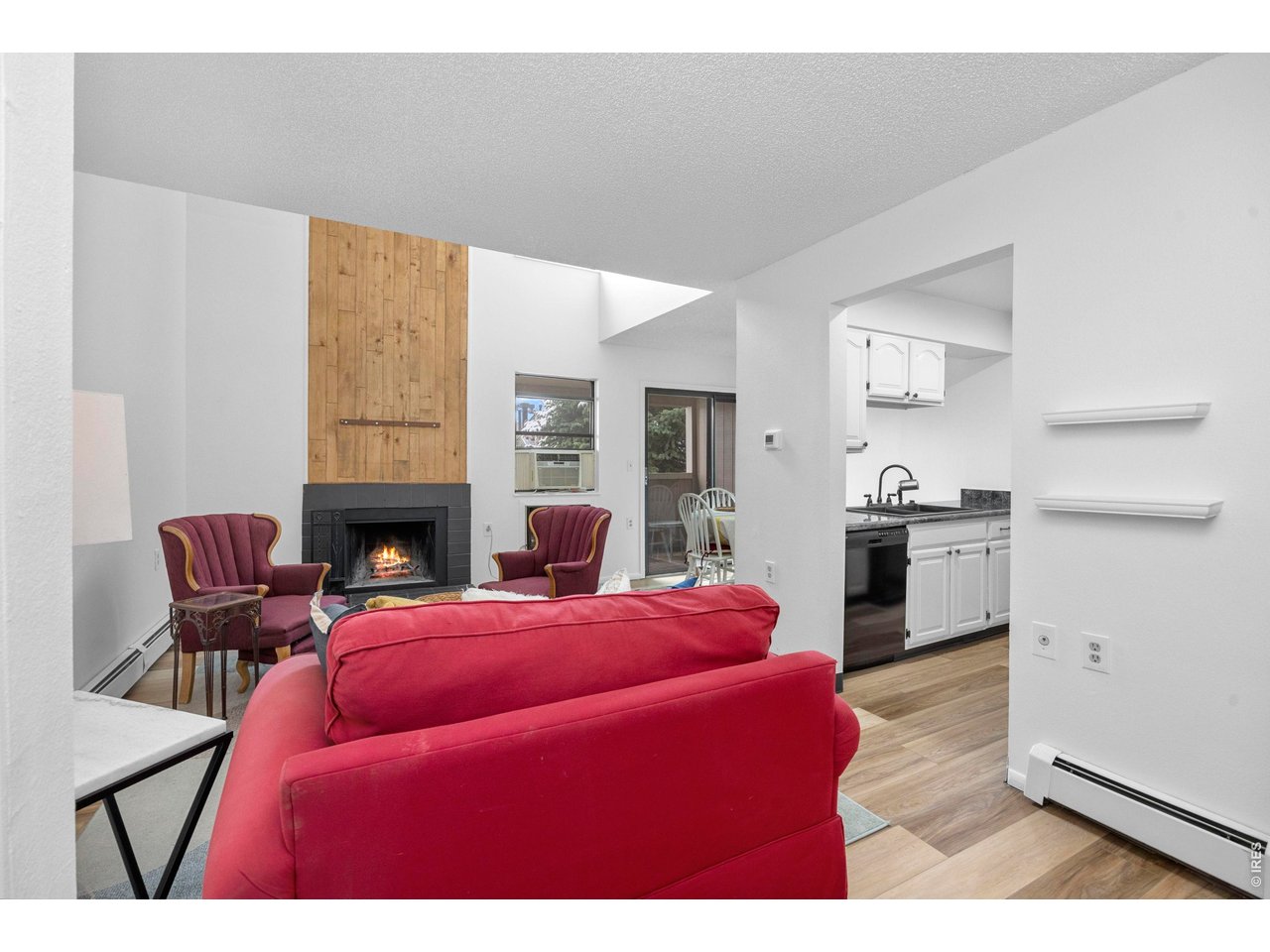 3400 Stanford Road, Unit B223 Fort Collins, CO 80525 - Photo 6 of 34 a living room with furniture kitchen view and a fireplace