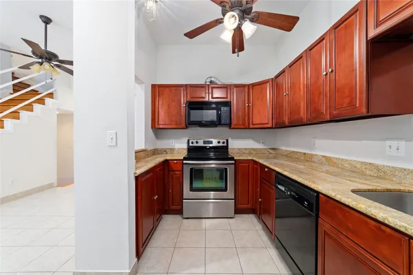 a kitchen with stainless steel appliances granite countertop a stove and a sink