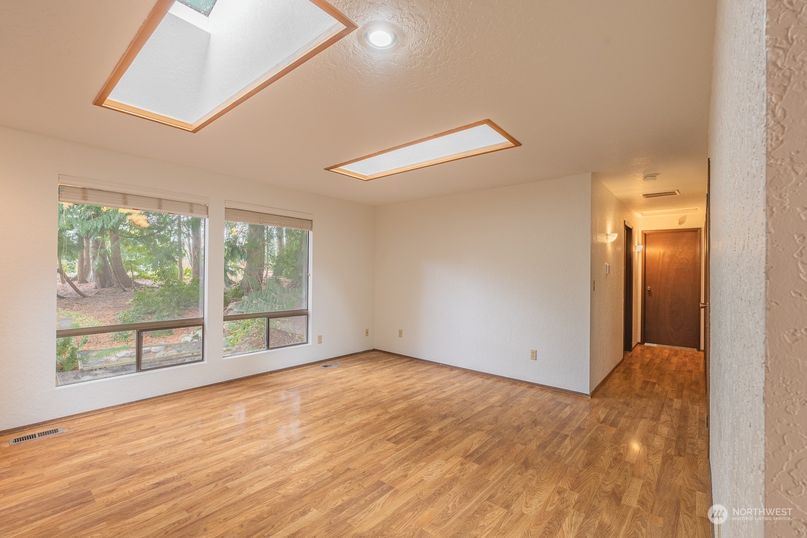 19628 35th Avenue Southeast Bothell, WA 98012 - Photo 6 of 31 an empty room with wooden floor and windows