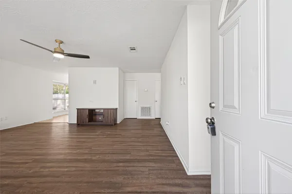 wooden floor in an empty room with a window
