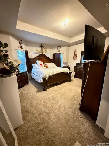 a bedroom with furniture and flat screen tv