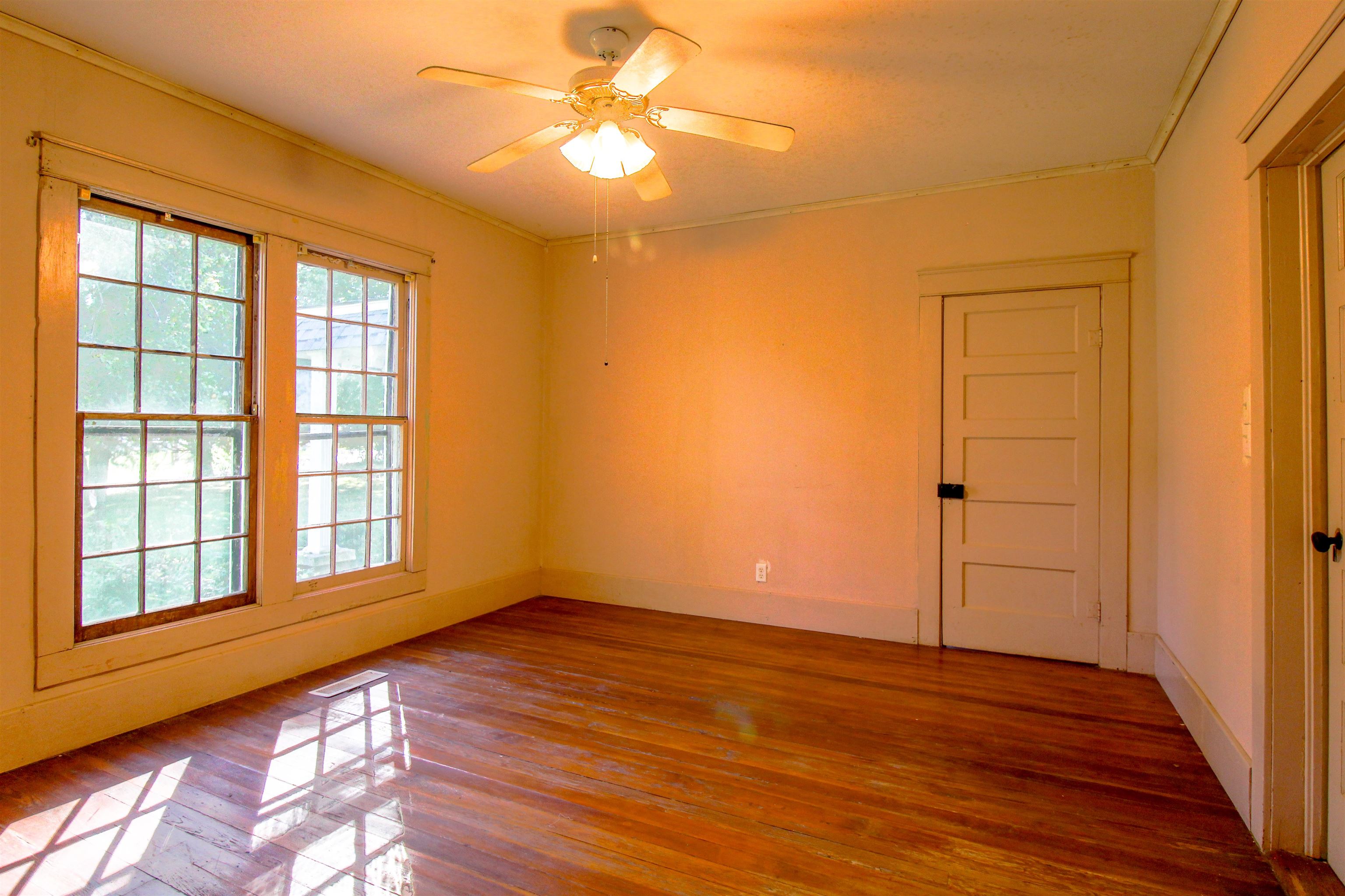 2440 Edith-Nankipoo Road Ripley, TN 38063 - Photo 12 of 27 a view of an empty room with wooden floor and a window