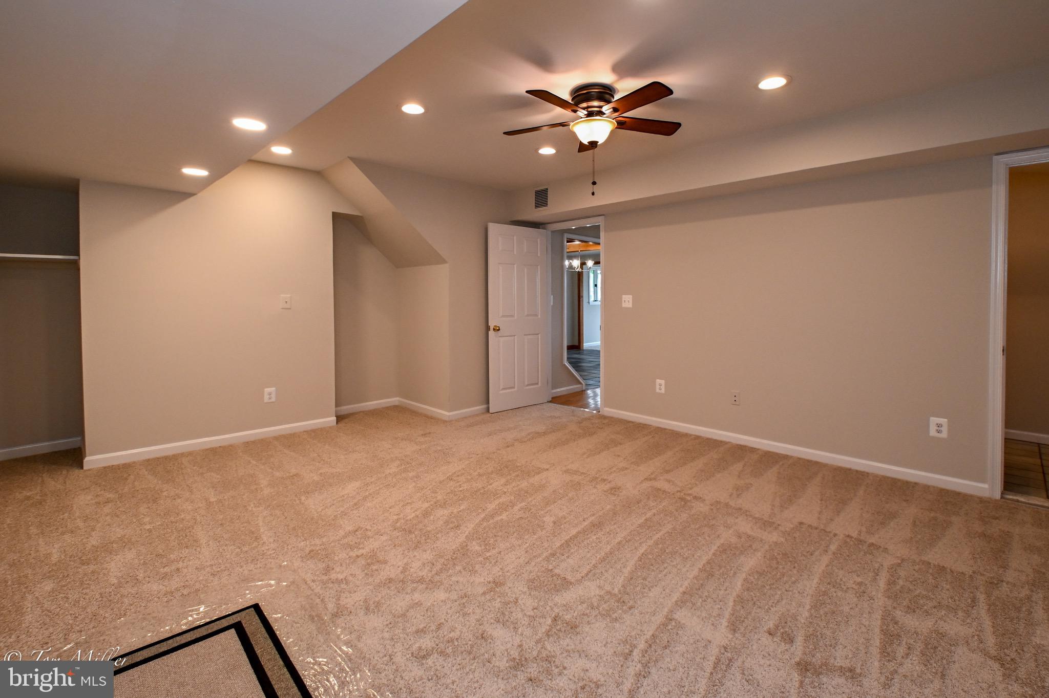1135 Beech Drive Baltimore, MD 21220 - Photo 14 of 53 a view of an empty room with a chandelier fan