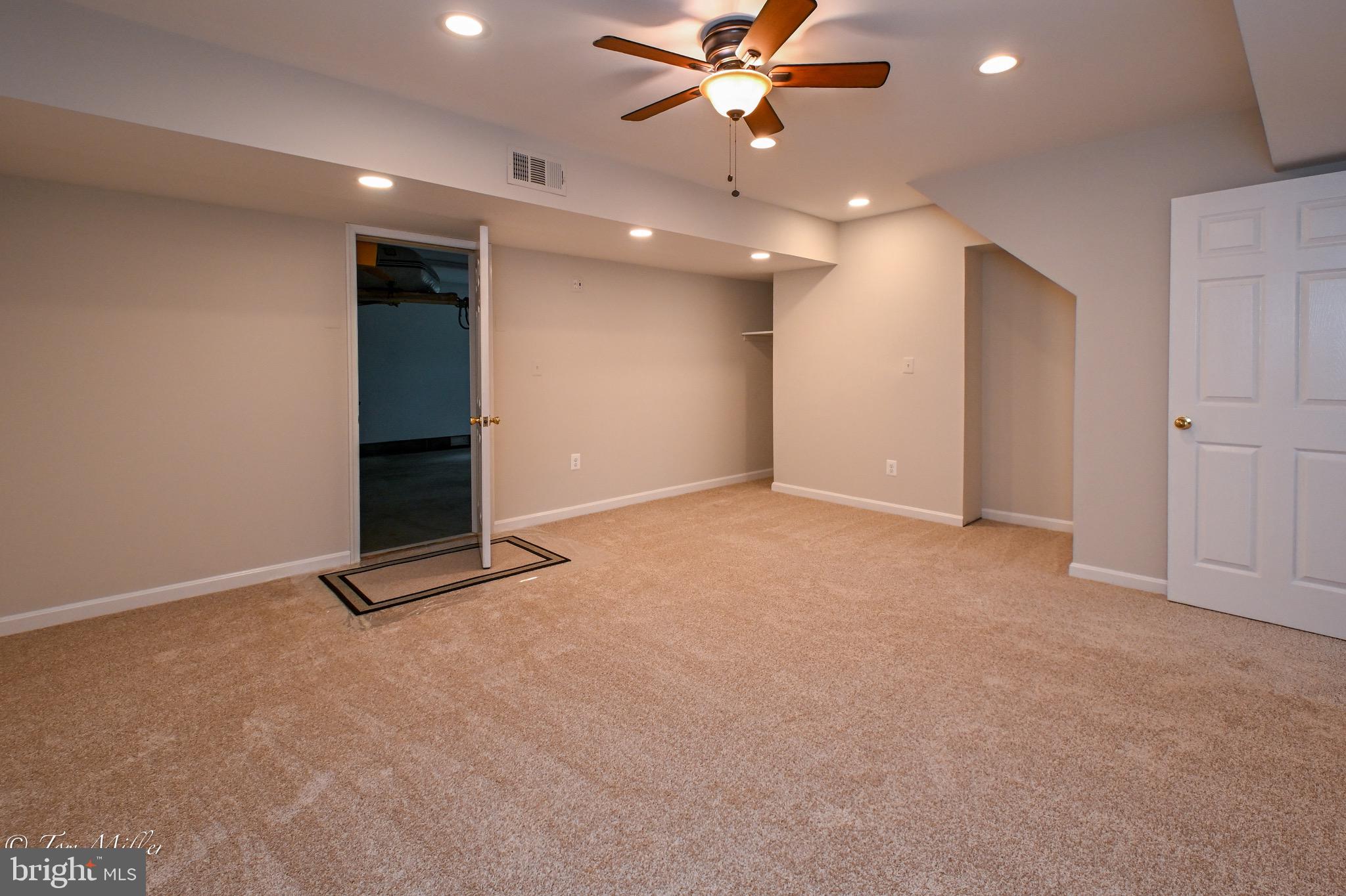 1135 Beech Drive Baltimore, MD 21220 - Photo 15 of 53 a view of an empty room with a fan