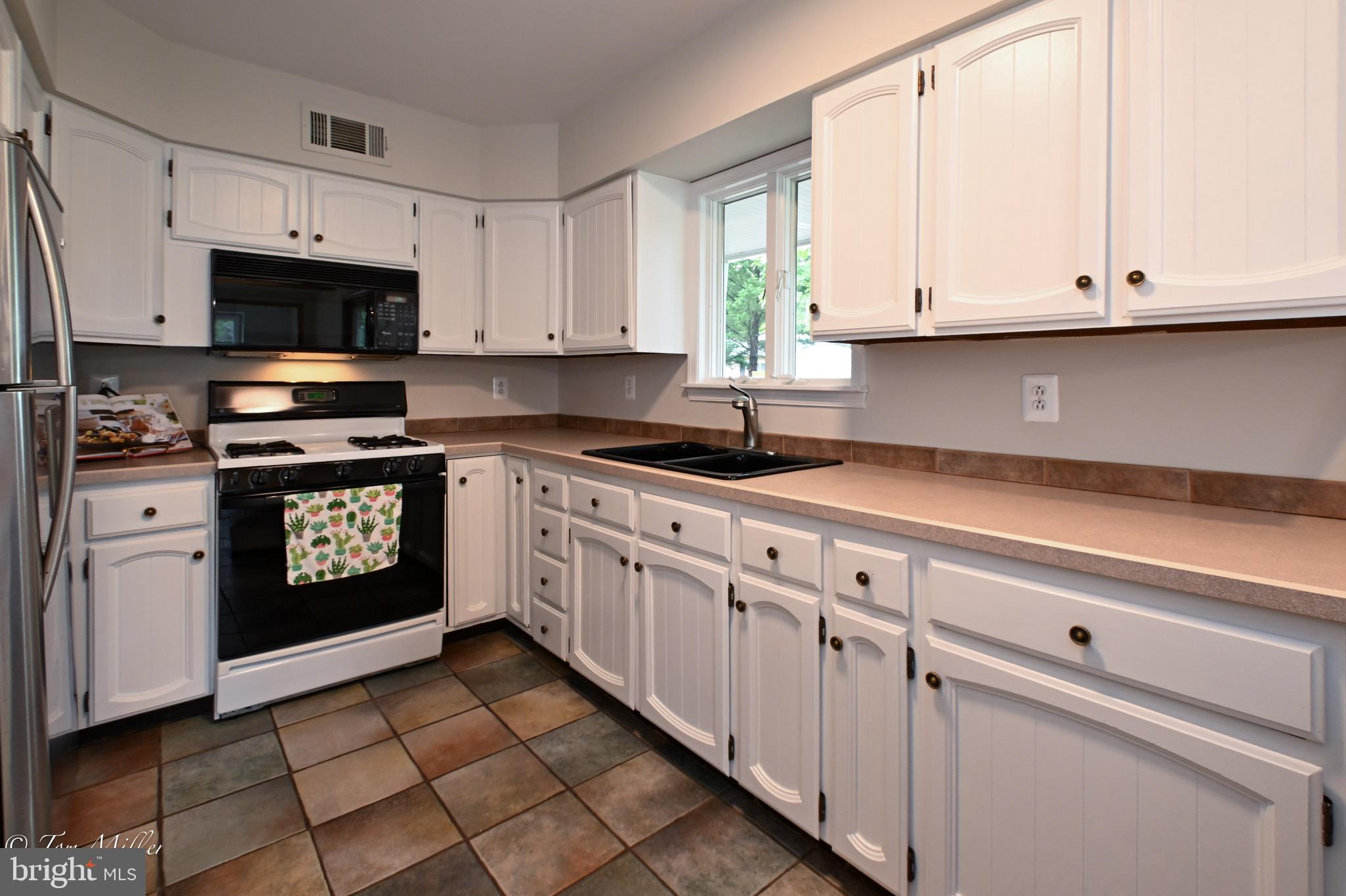 1135 Beech Drive Baltimore, MD 21220 - Photo 18 of 53 a kitchen with granite countertop white cabinets and stainless steel appliances