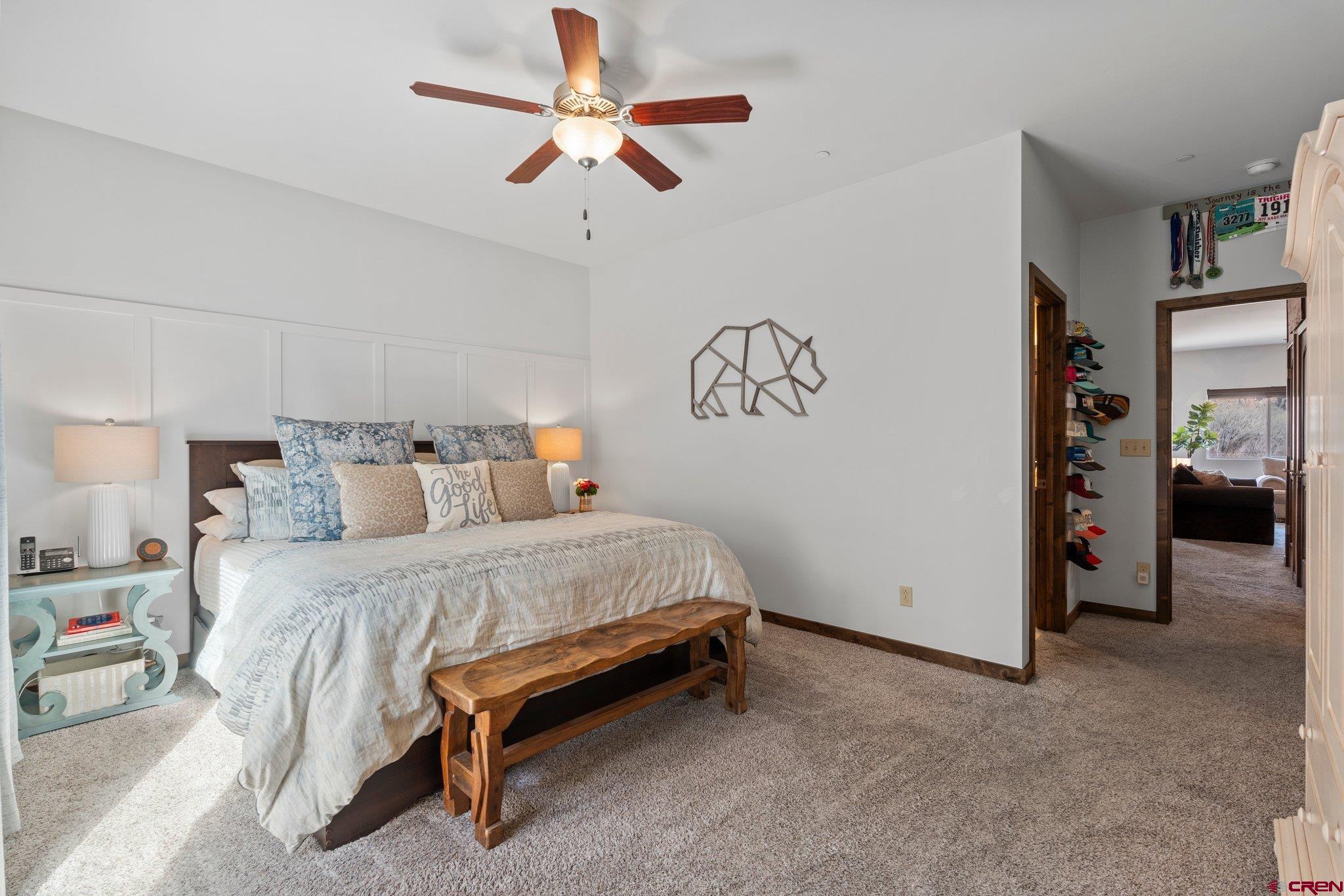 1422 Animas View Drive, Unit 25 Durango, CO 81301 - Photo 12 of 35 a spacious bedroom with a bed and a chandelier