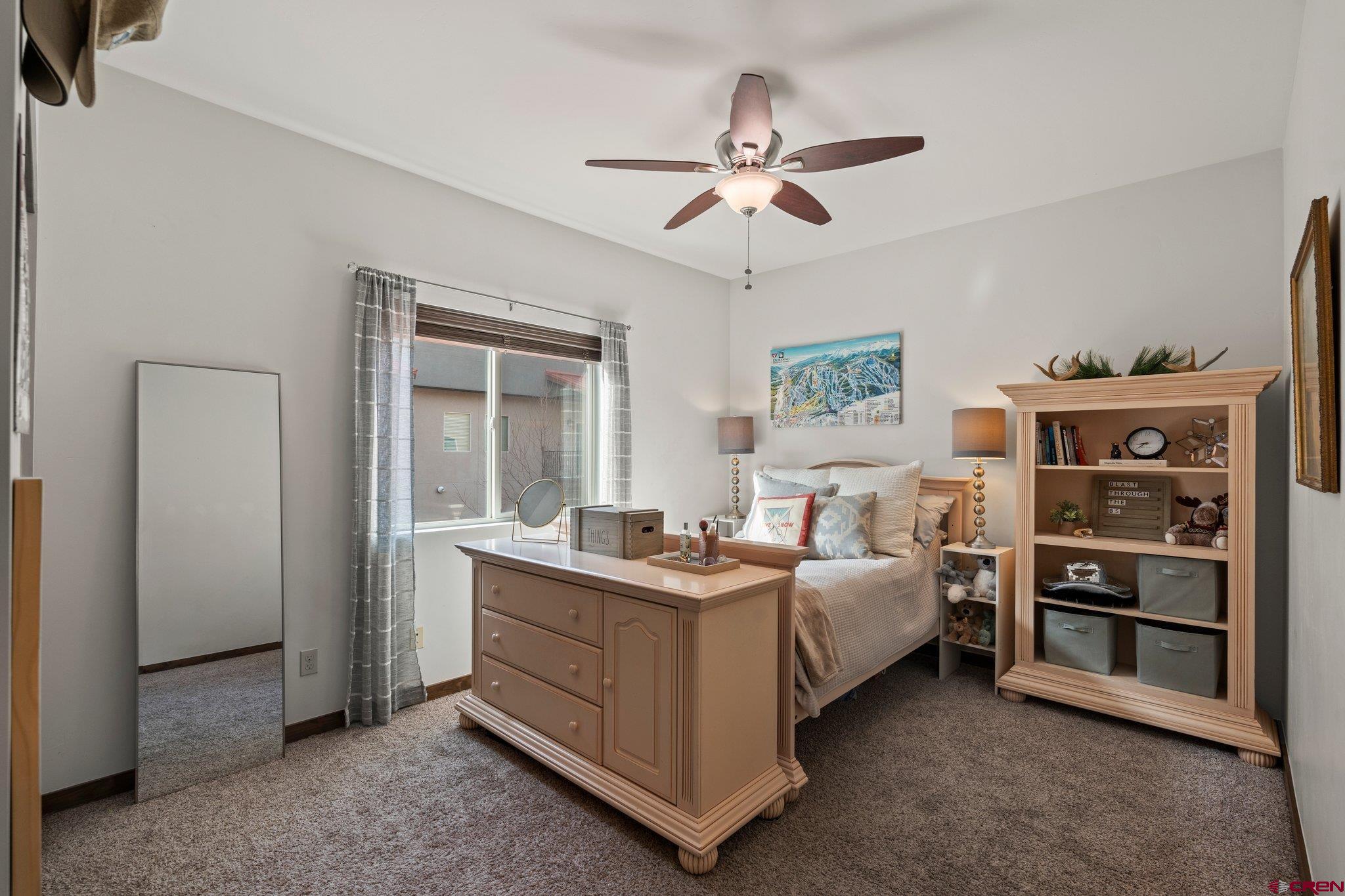 1422 Animas View Drive, Unit 25 Durango, CO 81301 - Photo 16 of 35 a bedroom with a bed and a chandelier