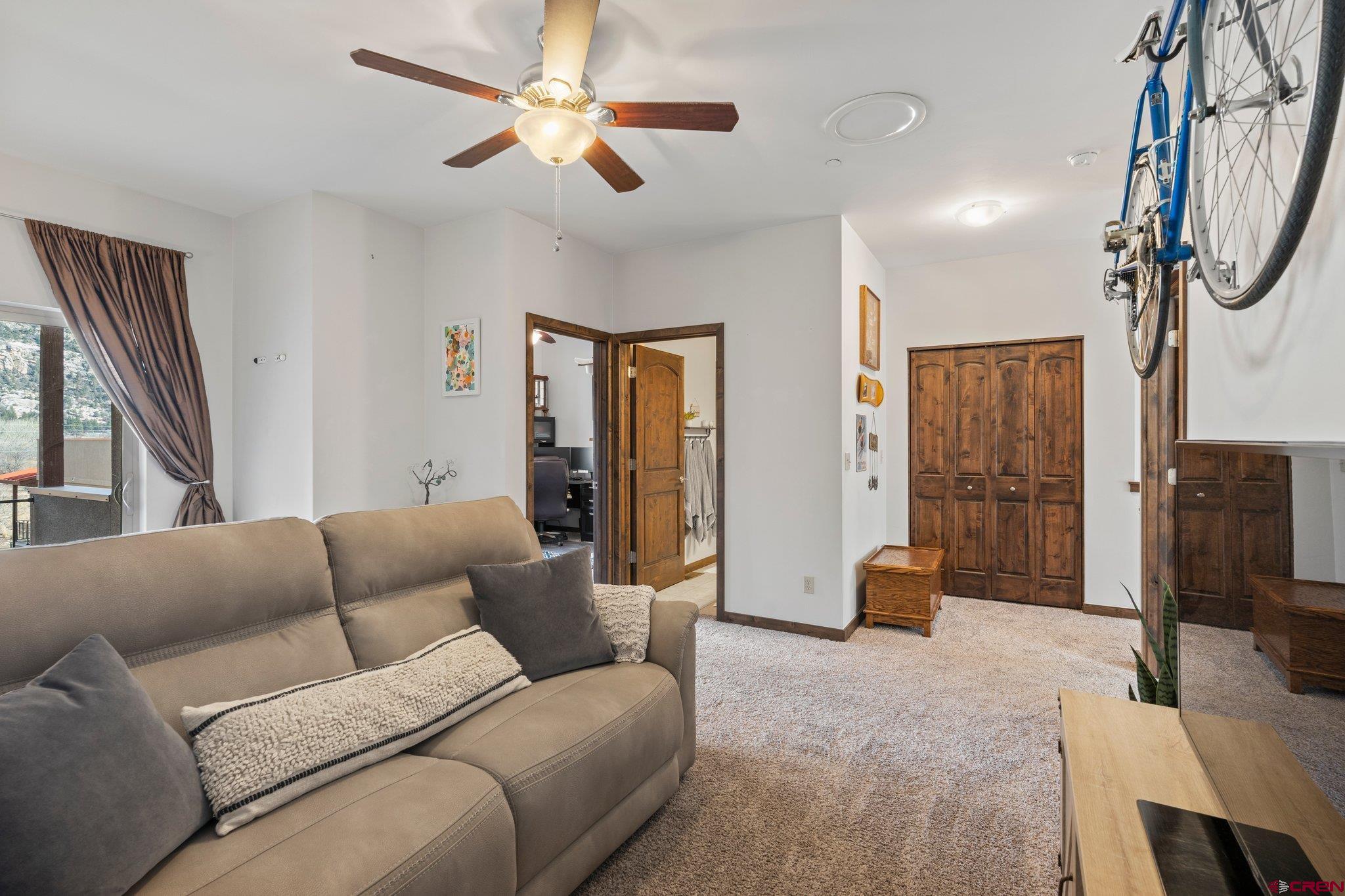 1422 Animas View Drive, Unit 25 Durango, CO 81301 - Photo 18 of 35 a living room with furniture a ceiling fan and a window