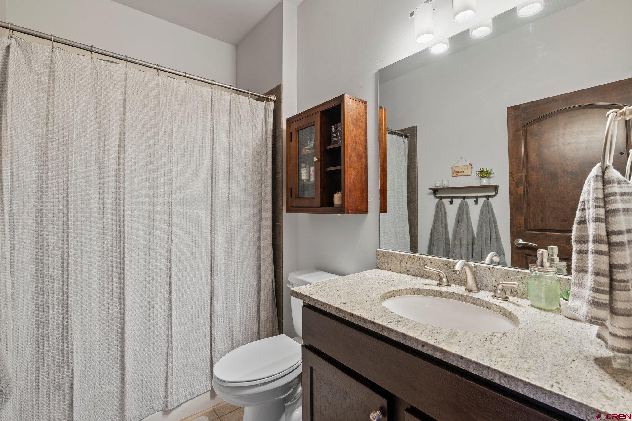 1422 Animas View Drive, Unit 25 Durango, CO 81301 - Photo 23 of 35 a bathroom with a granite countertop sink and a mirror