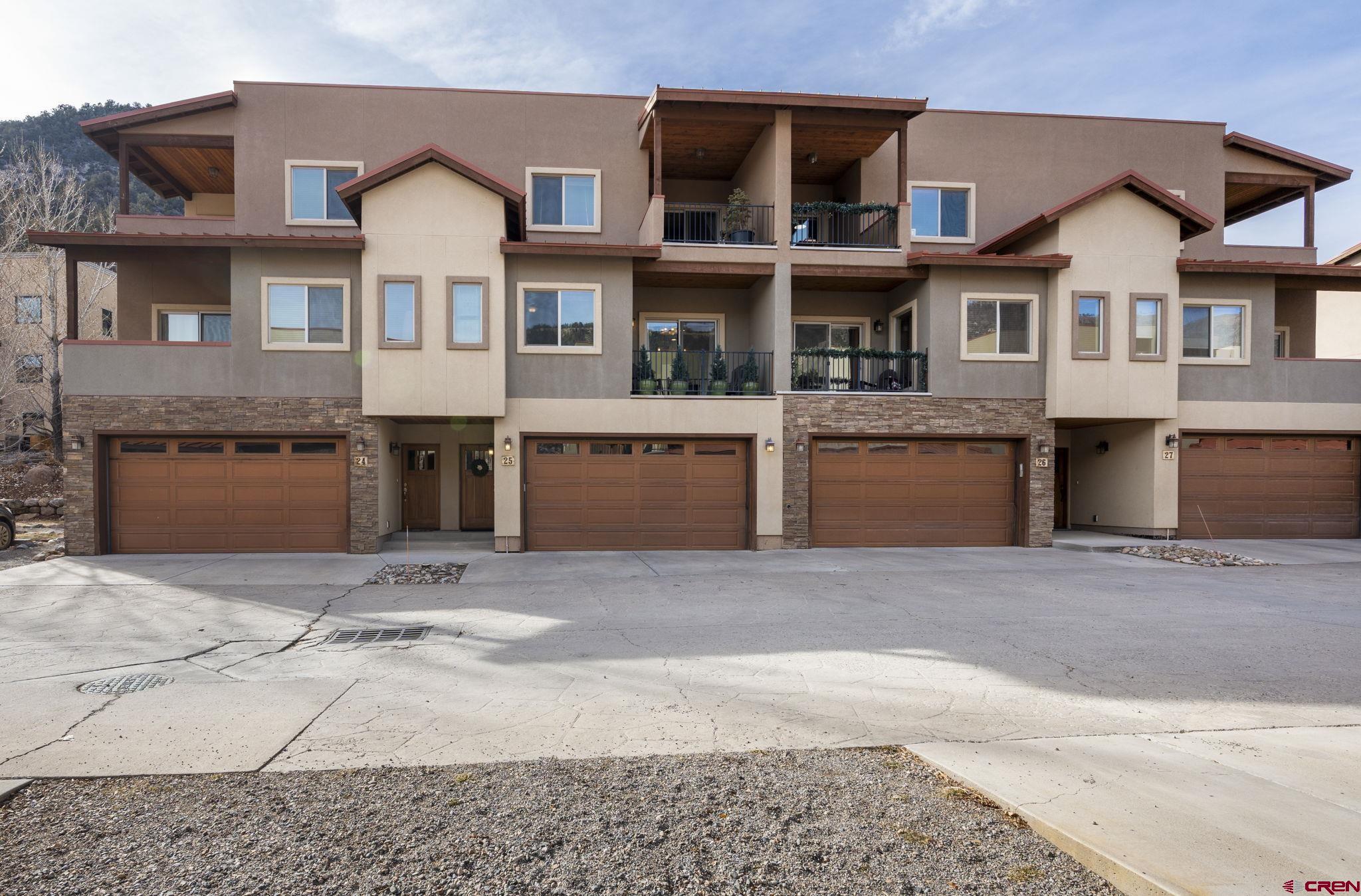 1422 Animas View Drive, Unit 25 Durango, CO 81301 - Photo 32 of 35 a front view of a house with a yard and garage