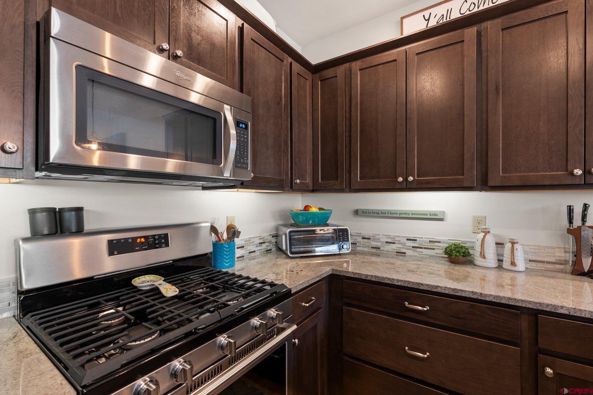 1422 Animas View Drive, Unit 25 Durango, CO 81301 - Photo 5 of 35 a kitchen with stainless steel appliances granite countertop a stove and a microwave