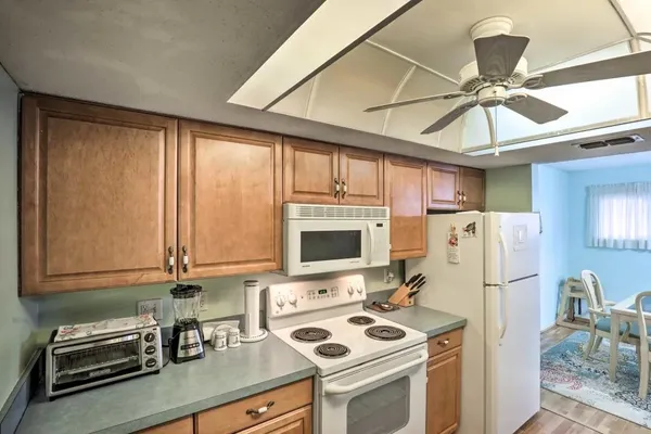 a kitchen with stainless steel appliances granite countertop a sink dishwasher stove and cabinets with wooden floor