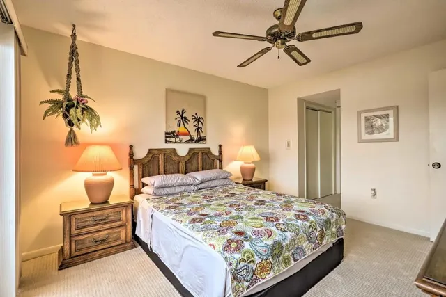 a bedroom with two beds and painting on the wall