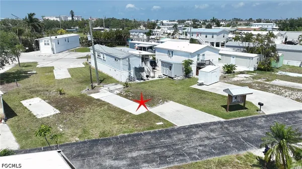 an aerial view of a house with a yard