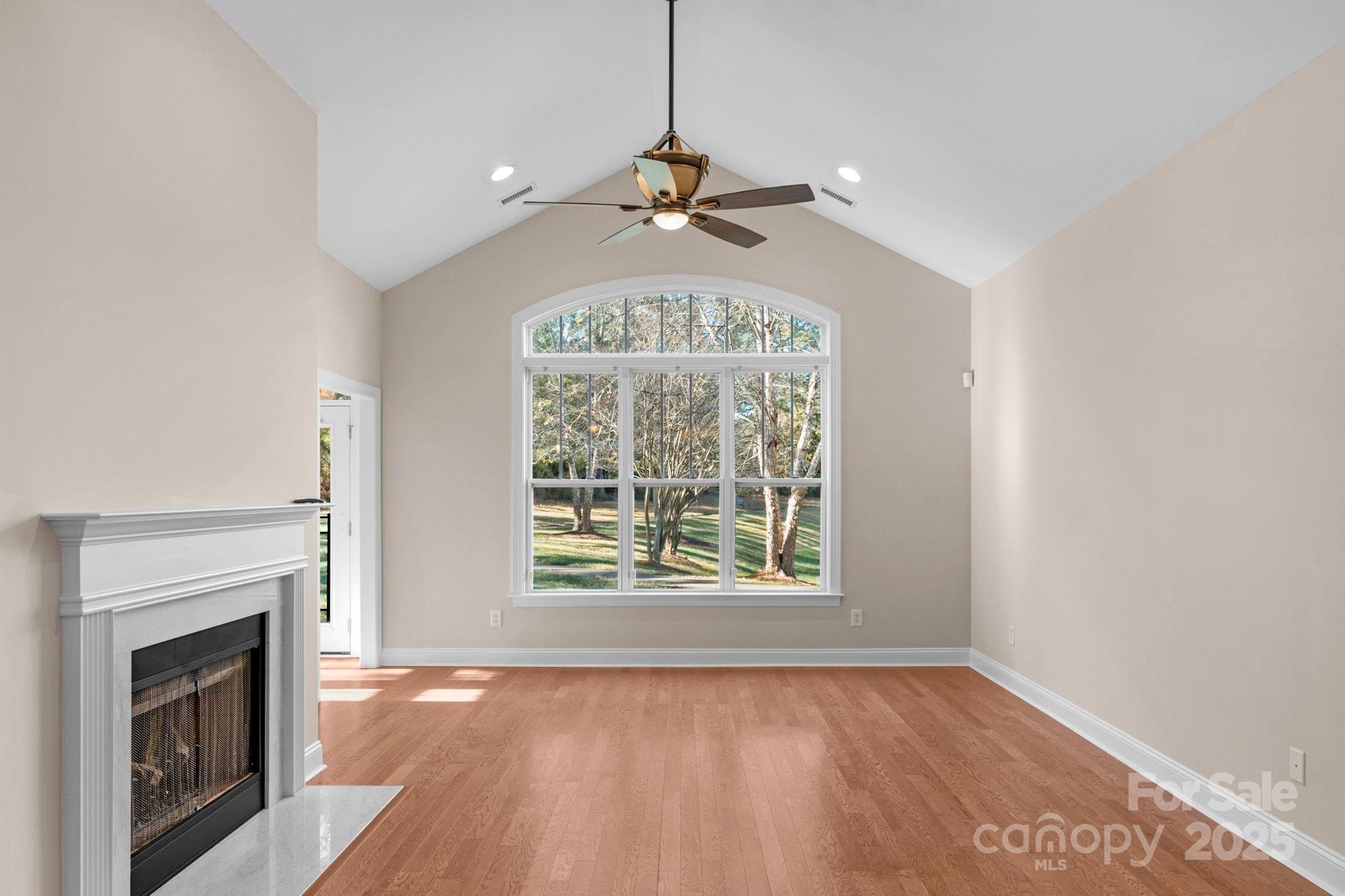 3038 Bellasera Way Matthews, NC 28105 - Photo 11 of 43 wooden floor in an empty room with a window