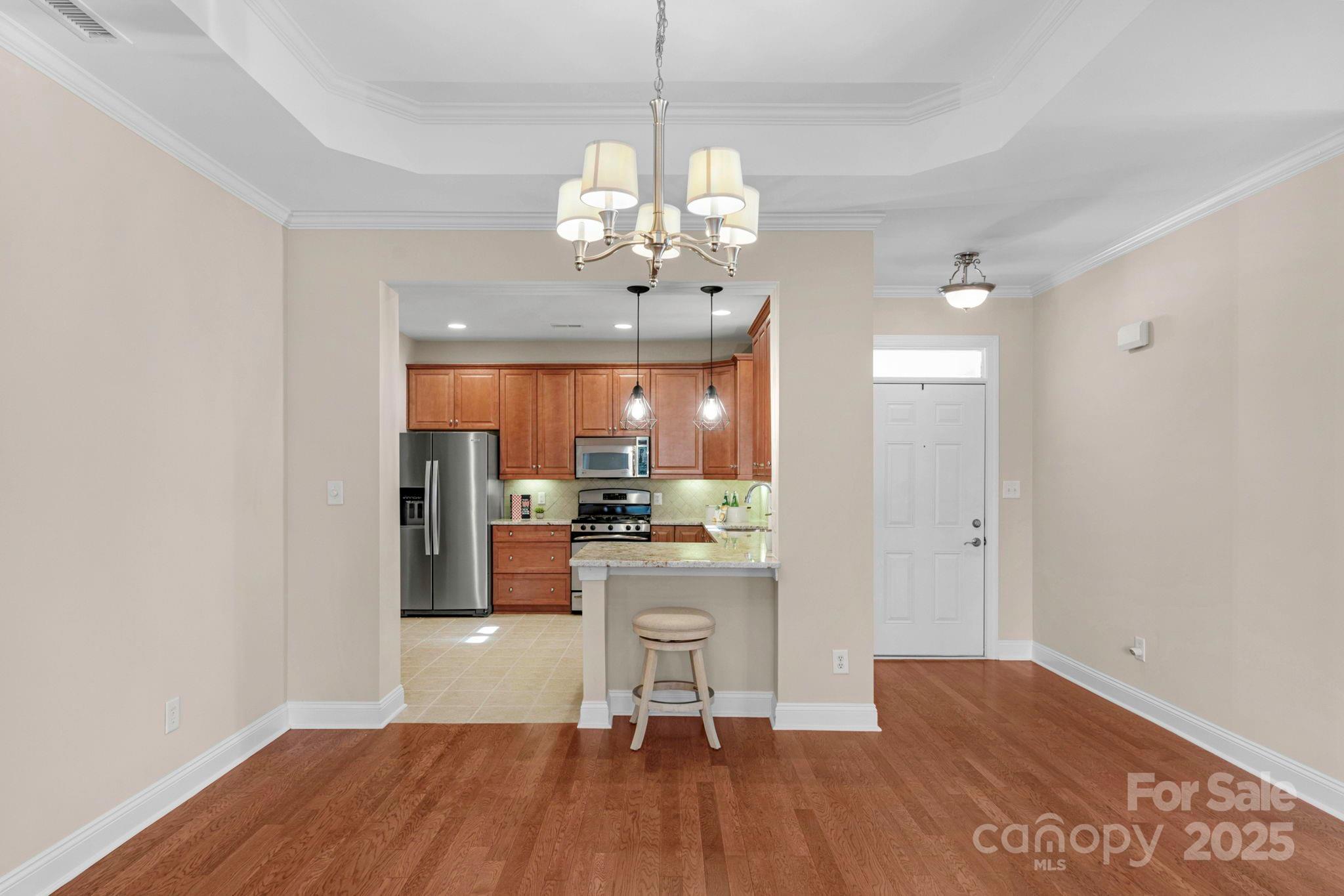 3038 Bellasera Way Matthews, NC 28105 - Photo 12 of 43 a view of a kitchen from the hallway