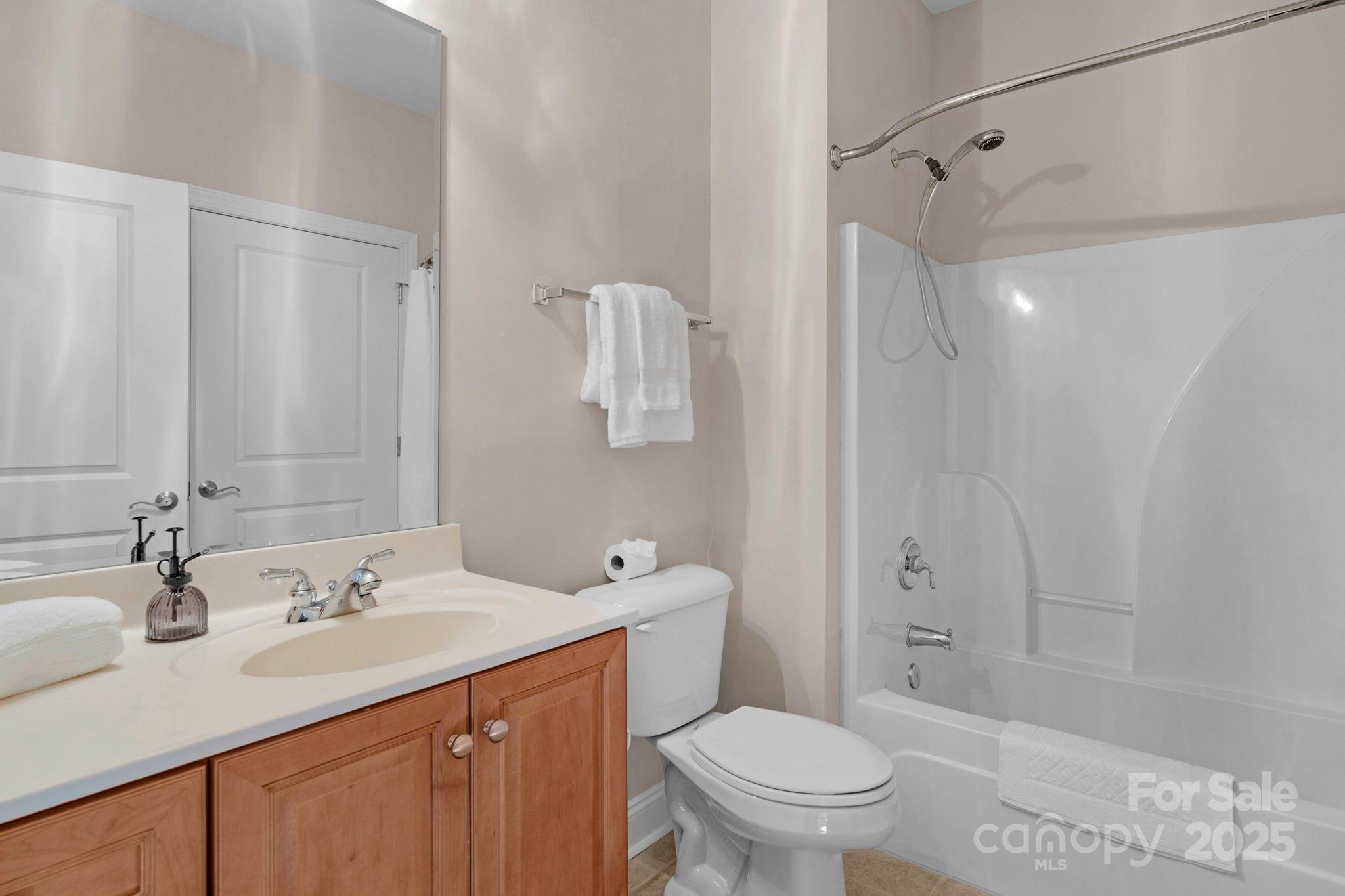 3038 Bellasera Way Matthews, NC 28105 - Photo 28 of 43 a bathroom with a sink toilet a mirror and shower