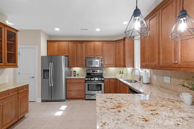 a kitchen with a refrigerator sink and stove