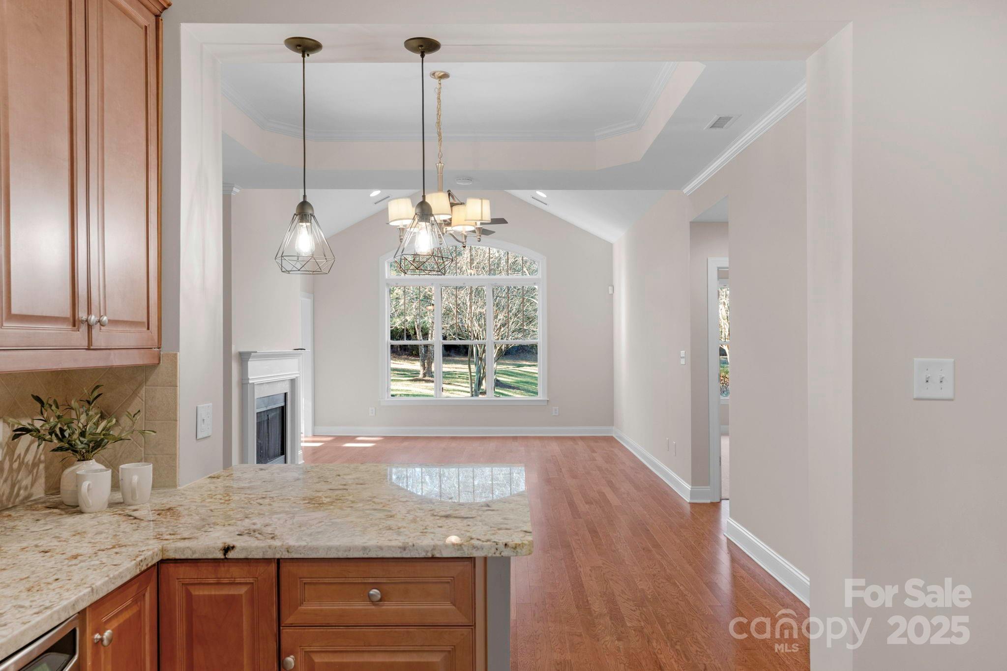 3038 Bellasera Way Matthews, NC 28105 - Photo 9 of 43 a view of a kitchen with granite countertop cabinets and a chandelier