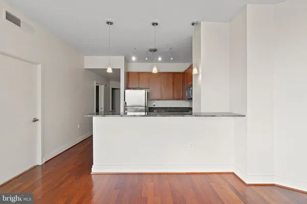 a view of a kitchen with wooden floor