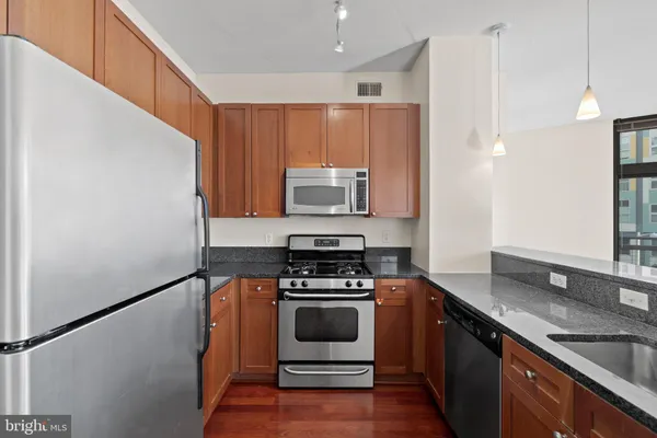a kitchen with a refrigerator and a sink