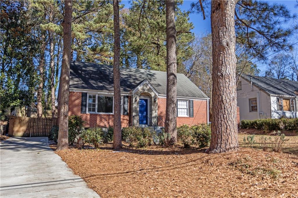 1926 Terry Mill Road Southeast Atlanta, GA 30316 - Photo 1 of 1 Stately stone canopy with double sconces warm the front entrance. Large lot with lovely, mature landscaping.