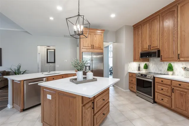 a kitchen with stainless steel appliances a sink stove and refrigerator