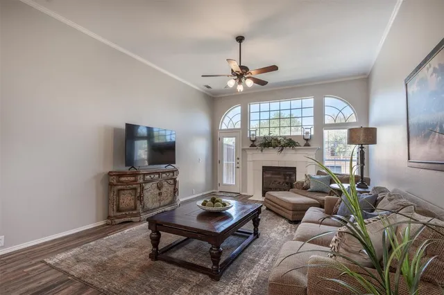 a living room with furniture a fireplace and a flat screen tv