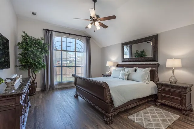 a bedroom with a bed and a large window