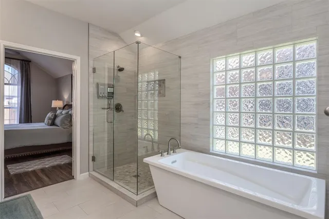 a bathroom with a bathtub and a shower
