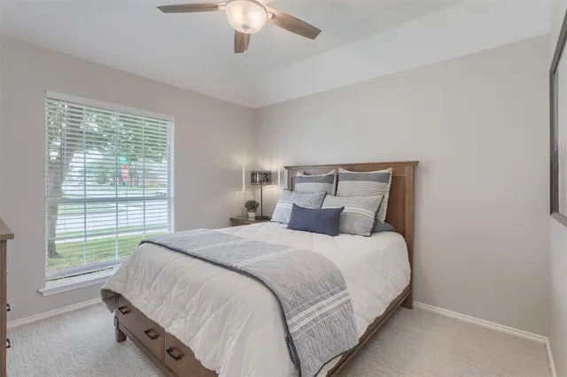 a bedroom with a large bed and a chandelier