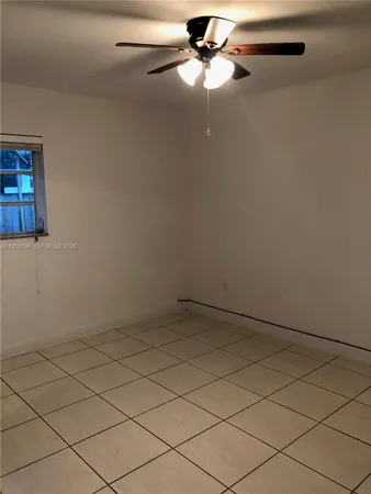 an empty room with a ceiling fan
