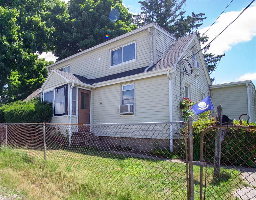 52 Adams Street Stoughton, MA 02072 - Photo 1 of 3 a backyard of a house with plants and large tree