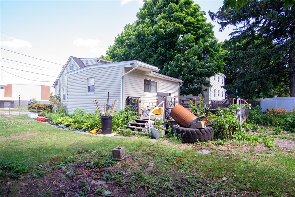 52 Adams Street Stoughton, MA 02072 - Photo 3 of 3 a front view of a house with garden and trees