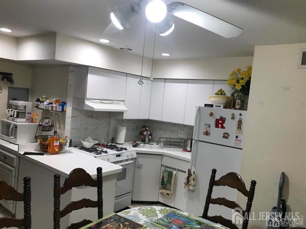 197 Evergreen Road Edison, NJ 08837 - Photo 2 of 7 a kitchen with a sink appliances and cabinets