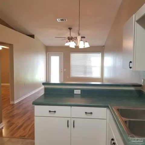 a kitchen with a sink and chandelier