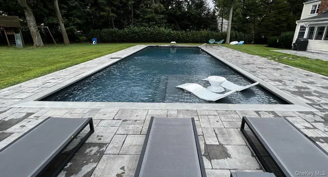 a front view of a house with a yard table and chairs