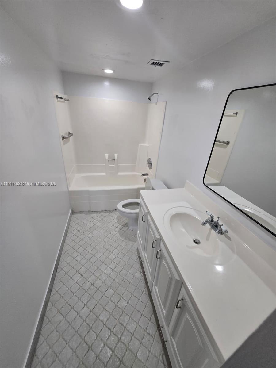 13499 Biscayne Boulevard, Unit 604 North Miami, FL 33181 - Photo 11 of 14 a bathroom with a double vanity sink a mirror and a bathtub