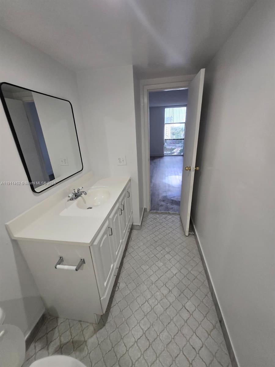 13499 Biscayne Boulevard, Unit 604 North Miami, FL 33181 - Photo 12 of 14 a bathroom with a sink and mirror
