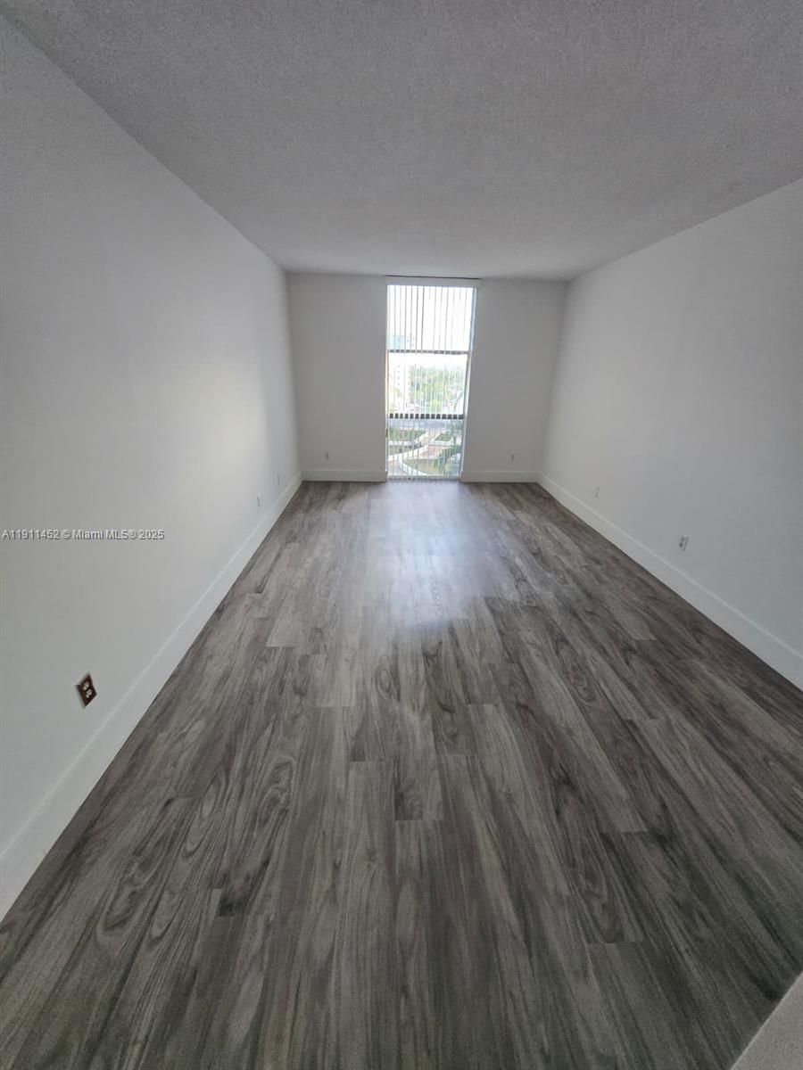 13499 Biscayne Boulevard, Unit 604 North Miami, FL 33181 - Photo 8 of 14 a view of empty room with wooden floor