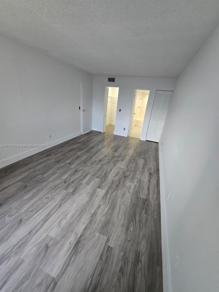 13499 Biscayne Boulevard, Unit 604 North Miami, FL 33181 - Photo 9 of 14 a view of empty room with wooden floor