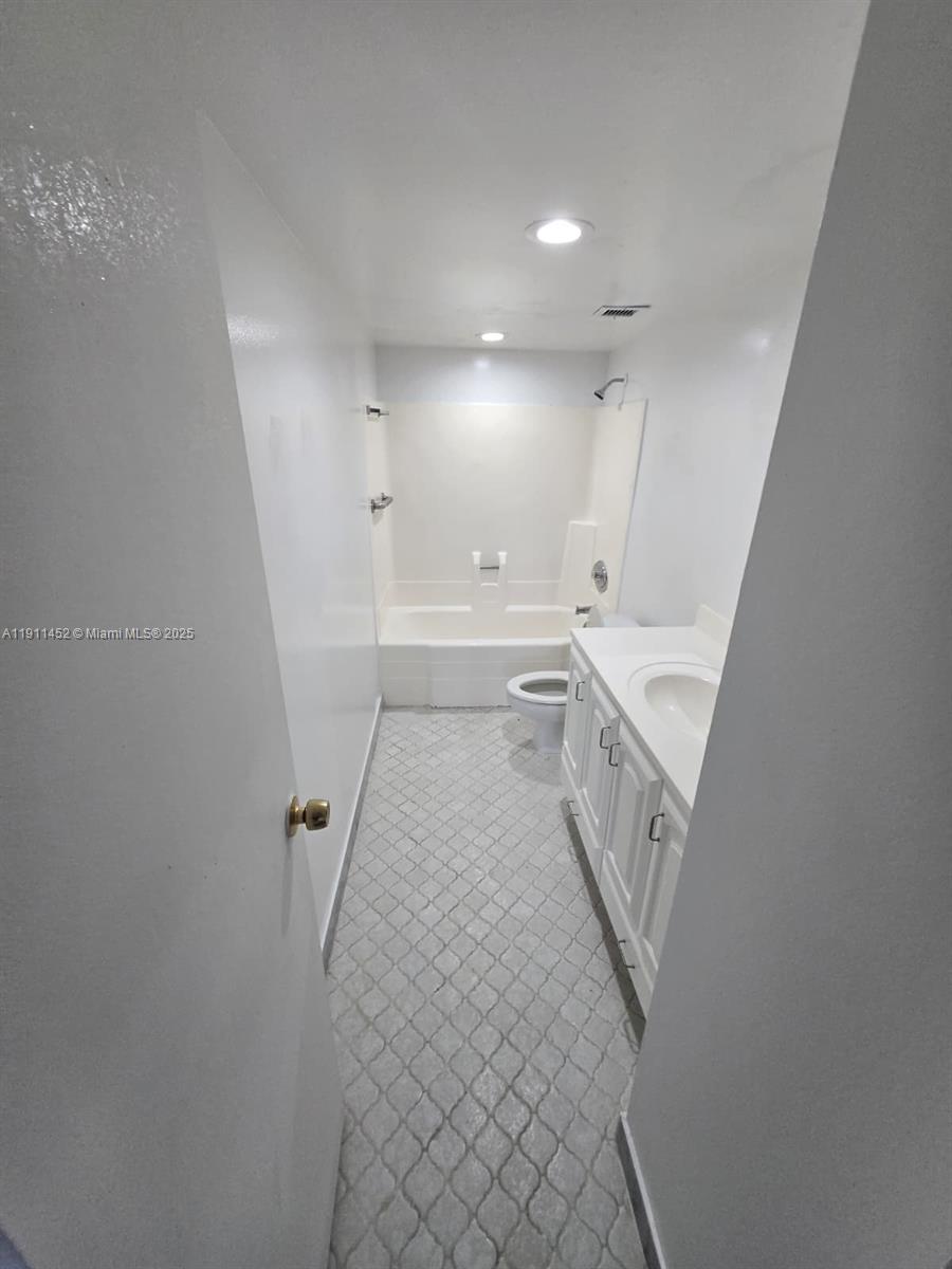 13499 Biscayne Boulevard, Unit 604 North Miami, FL 33181 - Photo 10 of 14 a bathroom with a sink a mirror and a toilet