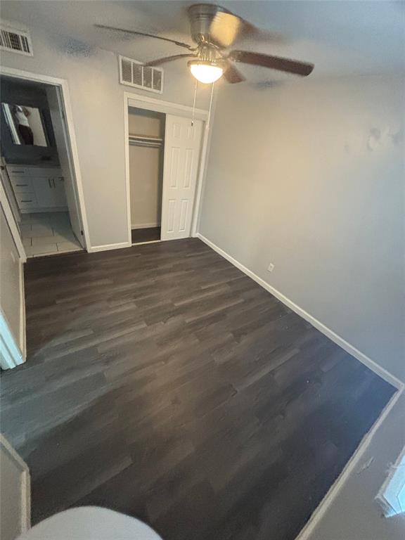301 Rolston Road, Unit 317103 Irving, TX 75060 - Photo 4 of 9 Room featuring dark wood-finish flooring, light gray walls, and a ceiling fan with integrated lighting
