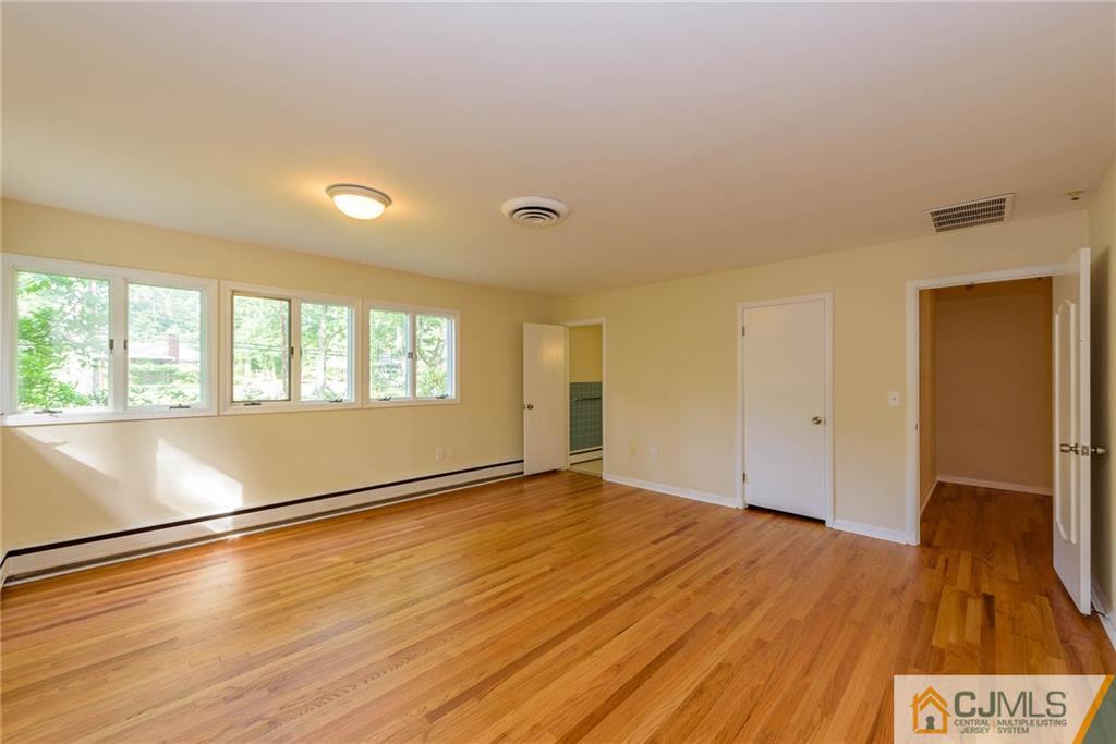 565 Foothill Road Bridgewater, NJ 08807 - Photo 14 of 25 a view of an empty room with wooden floor and a window