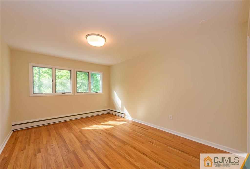 565 Foothill Road Bridgewater, NJ 08807 - Photo 16 of 25 an empty room with wooden floor and windows