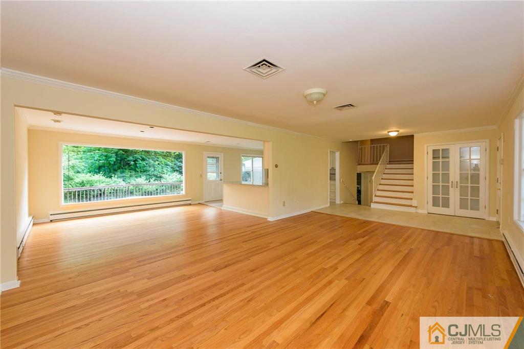 565 Foothill Road Bridgewater, NJ 08807 - Photo 3 of 25 a view of an empty room with a window and wooden floor