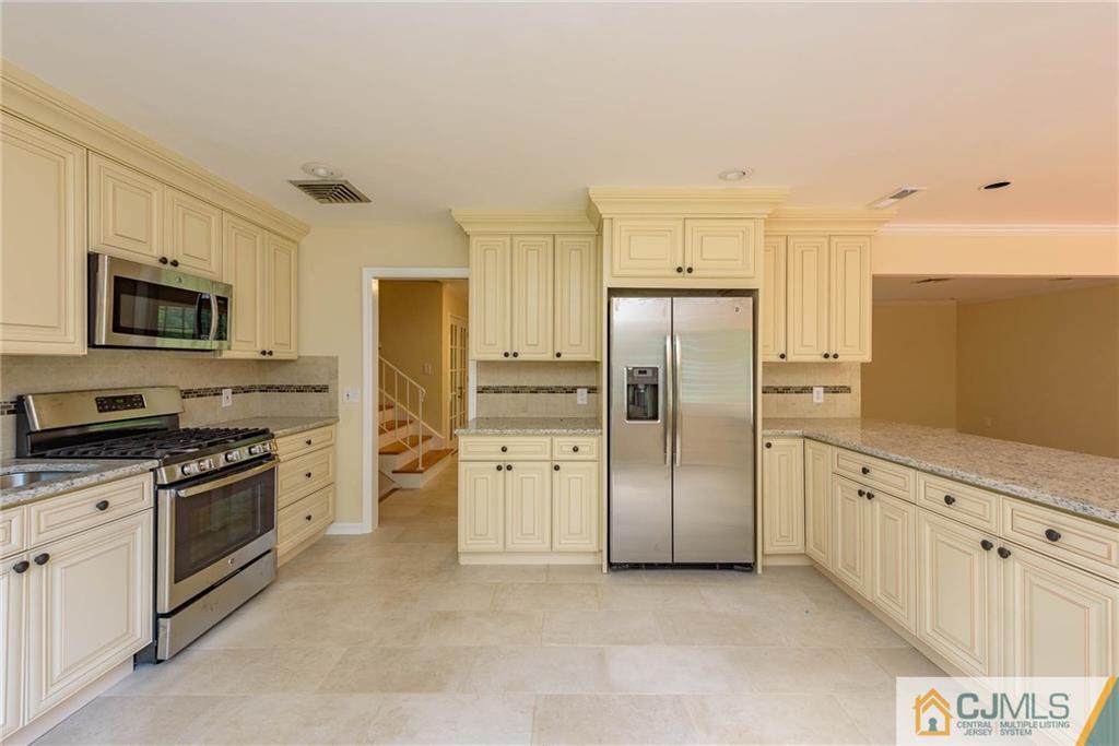 565 Foothill Road Bridgewater, NJ 08807 - Photo 6 of 25 a kitchen with stainless steel appliances a refrigerator sink and stove